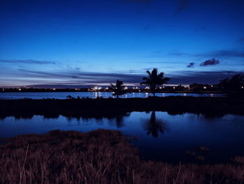 Scenic view of lake against sky at night