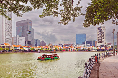 Boats in river in city