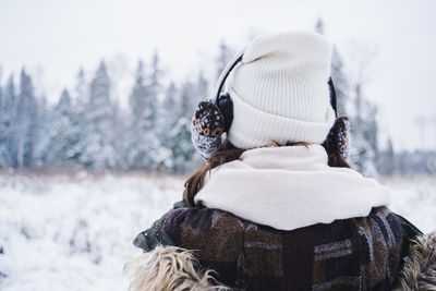 Rear view of person on snow covered field