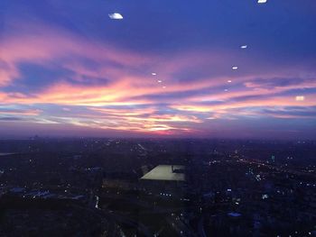 High angle view of illuminated buildings against sky at sunset