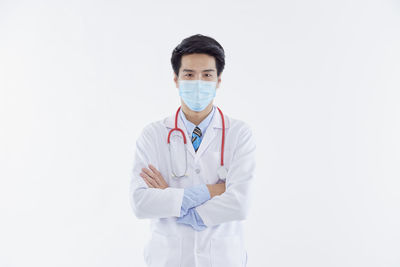 Portrait of man standing against white background