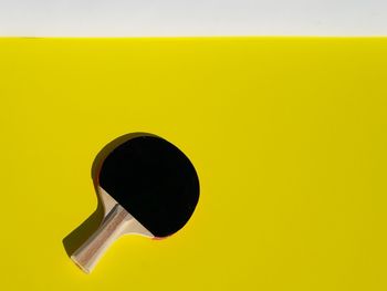 Close-up of yellow object over white background