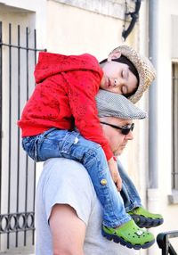 Father carrying son on shoulder while sleeping