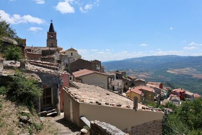 Buildings in town against sky