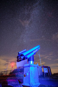 Information sign against sky at night