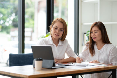 Smiling businesswoman brainstorming at office