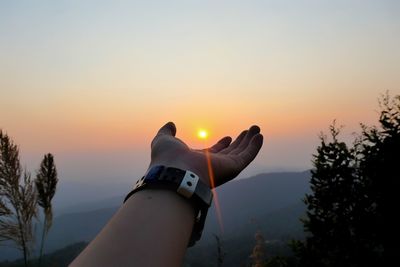 Person against orange sky during sunset