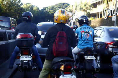 Rear view of people on street in city