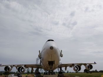 Low angle view of airplane on airport runway against sky