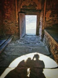 Low section of person by window against sky