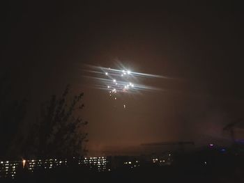 Low angle view of firework display at night