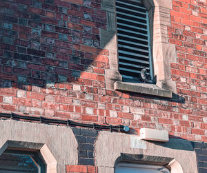 Low angle view of brick wall of building