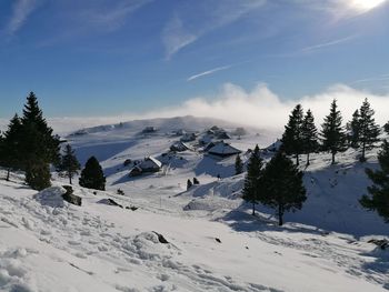 Scenic view of snow covered mountains against sky