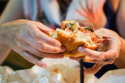 Close-up of man holding burger