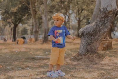 Full length of boy running on field