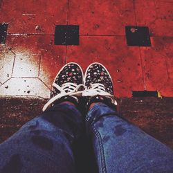 Low section of man standing on tiled floor