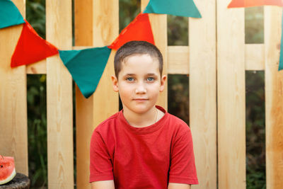 Portrait of smiling boy standing outdoors