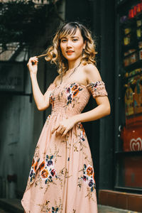 Portrait of woman standing against wall