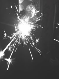 Low angle view of firework display at night