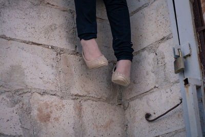 Low section of man standing on wall