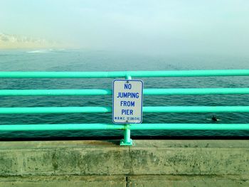 Signboard mounted on pier railing