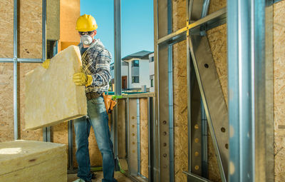 Rear view of man standing in factory