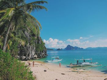 Scenic view of beach against blue sky