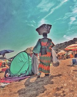 Rear view of tent on landscape against sky