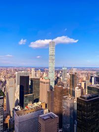 Modern buildings in city against blue sky