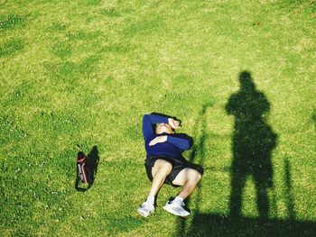 High angle view of people lying on field