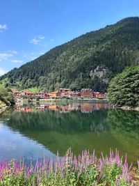 Scenic view of lake by mountain against sky