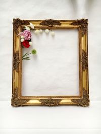 View of empty gold colored frame on wall