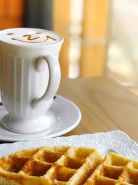 Close-up of coffee cup on table