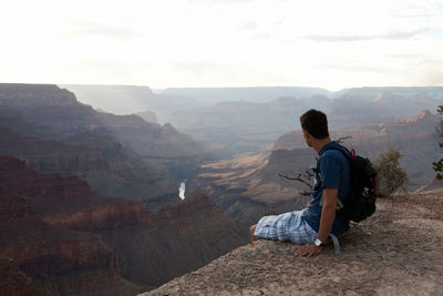 Man sitting on the edge of grand canyon