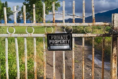 Information sign on metal fence