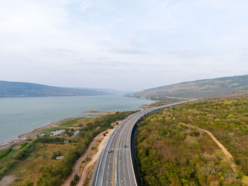 High angle view of road by sea against sky