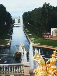 Fountain by river against sky