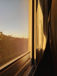 View of sunset through window
