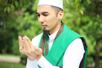 Close-up of man praying outdoors