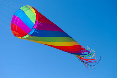 Low angle view of flag against clear blue sky