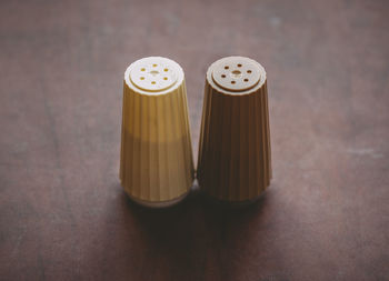 Close-up of salt and pepper shakers on table