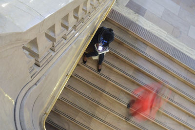 High angle view of man walking on staircase