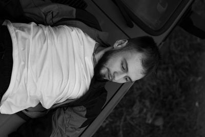 Low angle view of woman sitting on car