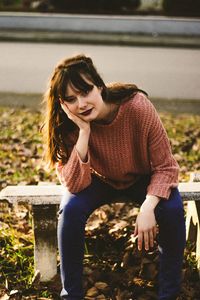 Smiling young woman sitting outdoors
