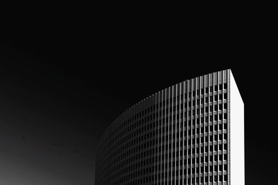 Low angle view of modern building against sky at night