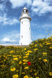 View of lighthouse on field against sky