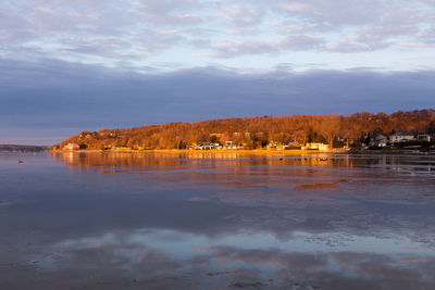 Scenic view of lake by building against sky