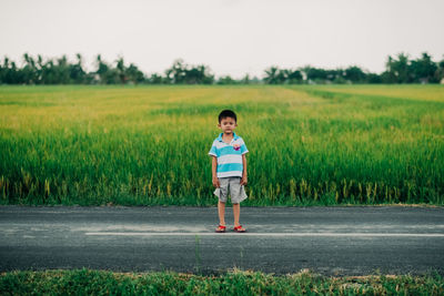 Full length of boy standing on field