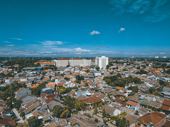 High angle view of townscape against blue sky