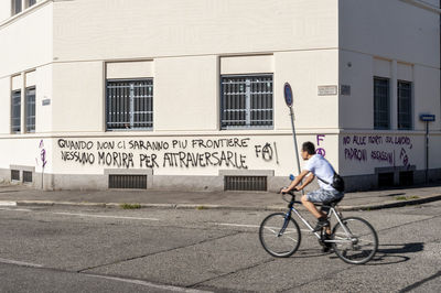 Man riding bicycle on city street